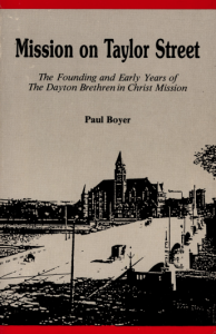 Book cover features a photograph of building alongside a road on which cars are driving. Title of the book reads: Mission on Taylor Street: The Founding and Early Years of the Dayton Brethren in Christ Mission.
