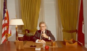 Ernest L. Boyer sitting at his desk at his welcoming party to Washington, DC as the new Commissioner of Education, 1977 (BCA)