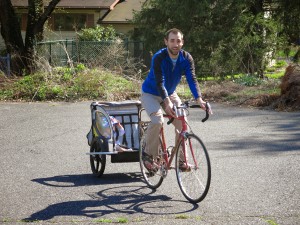 Here is Brandon pulling his son, Paxton, on a bicycle! 